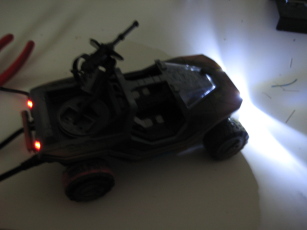 Photo of completed Warthog with light on, in dark room